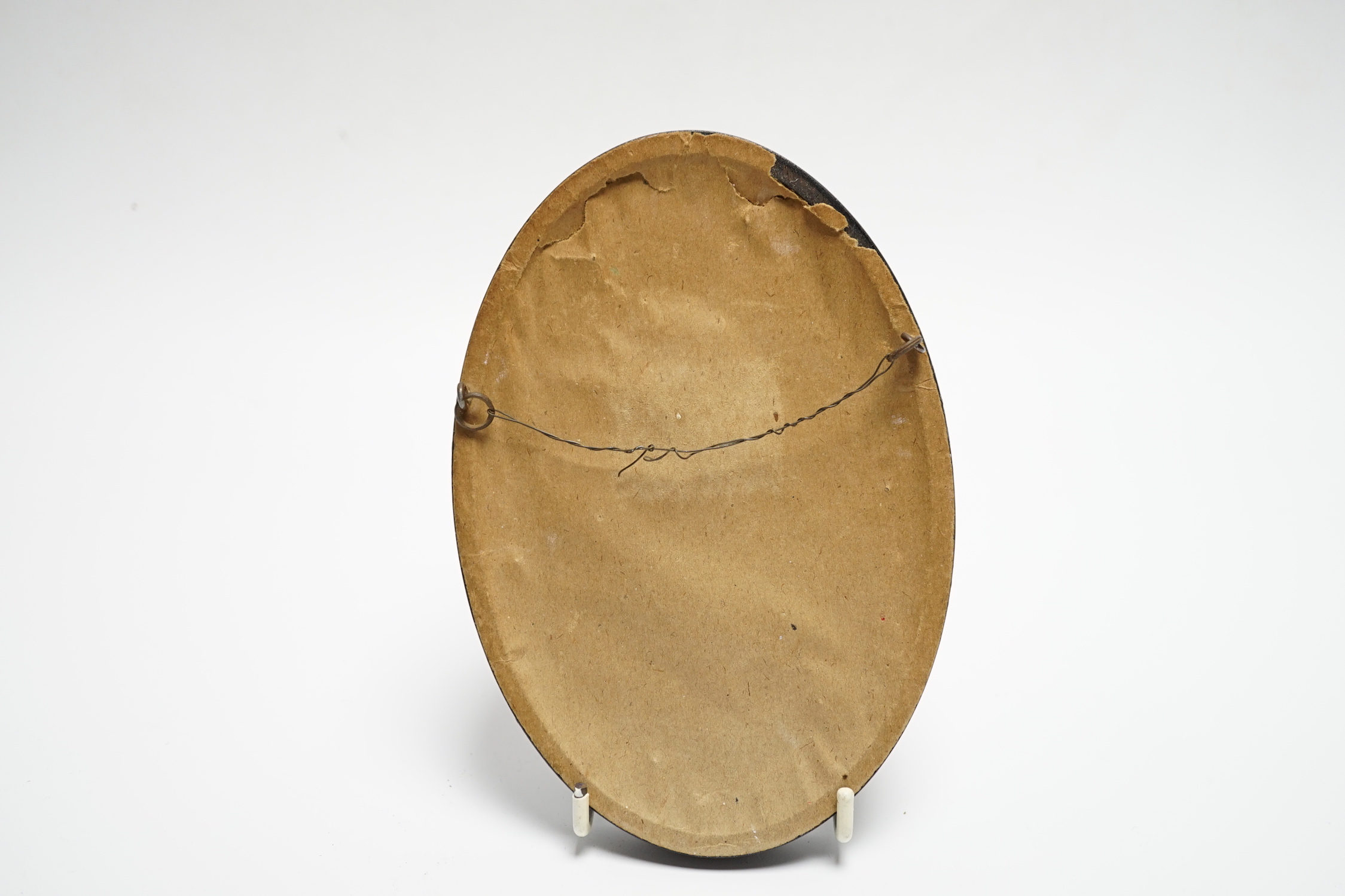 A small framed white metal oval plaque, modelled as a bust of Lord Nelson in relief, 86mm by 67mm.